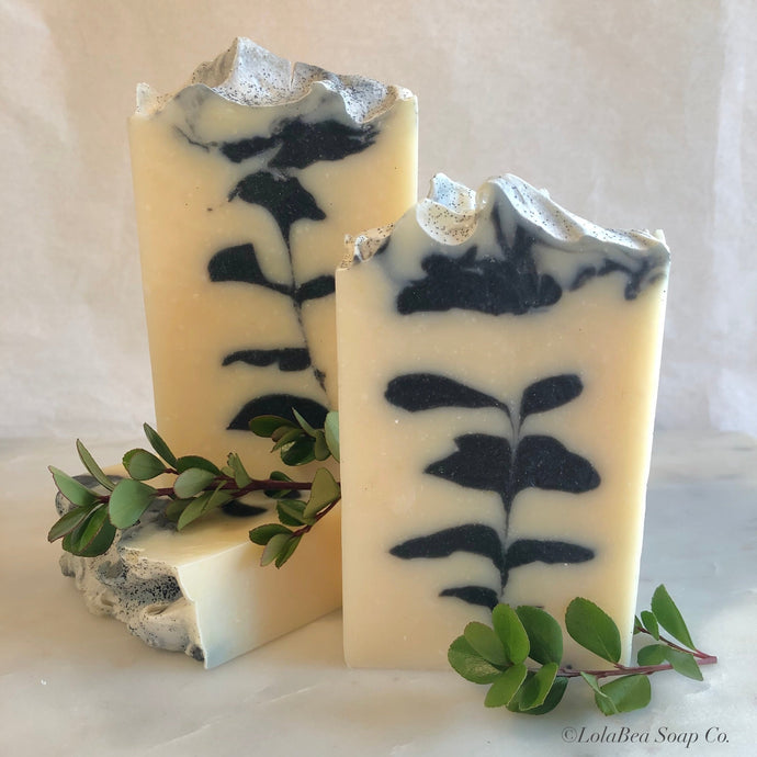 Nirvana buttermilk soap. Artisan soap bars. Cream with black leaf design in center.