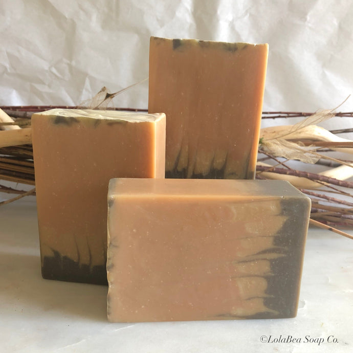 Rustic Woods Buttermilk Soap. Artisan made. Tan soap bars dark brown and yellow stripes floating from the bottom