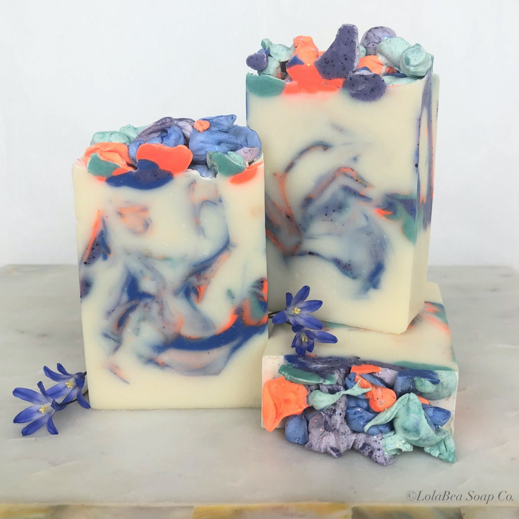 Artistic hand-poured soap bars. Swirls of bright orange, blue and purple.